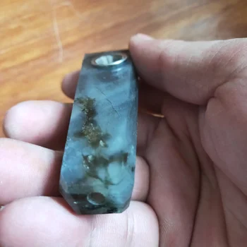 

Hand carved quartz crystal cigarette holder with natural colored feldspar