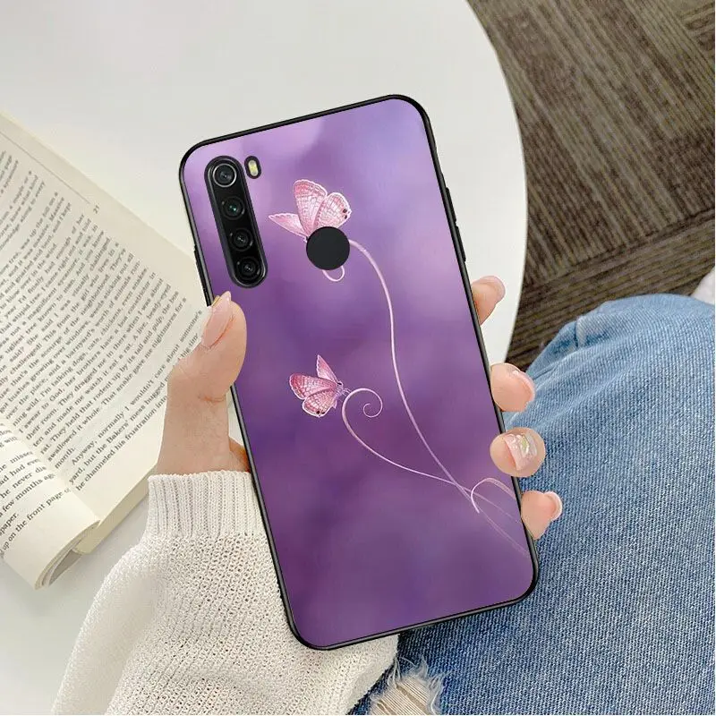 Red butterfly on white roses flower