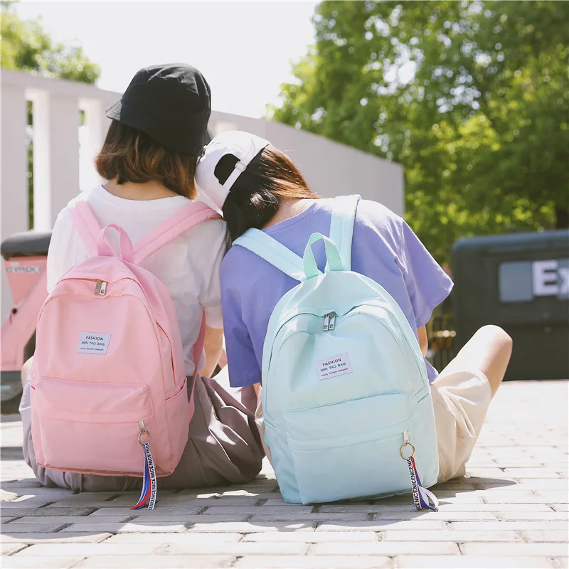 

Men's and women's solid color backpack high-capacity students Korean campus simple splash-proof fashion bag
