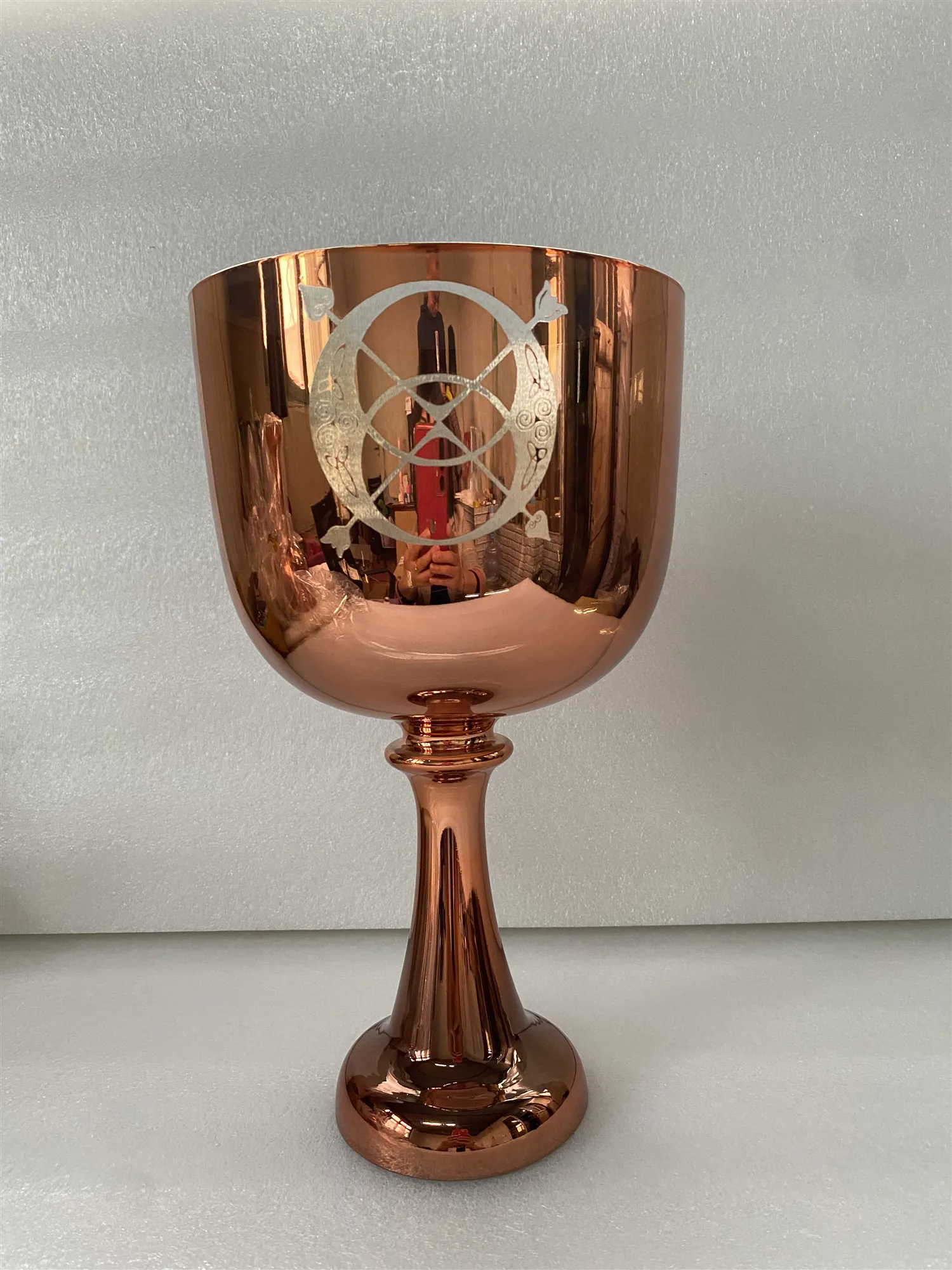 

Rose golden color crystal singing chalice 4th octave C Note Root chakra 432Hz with engravings for sound healing.