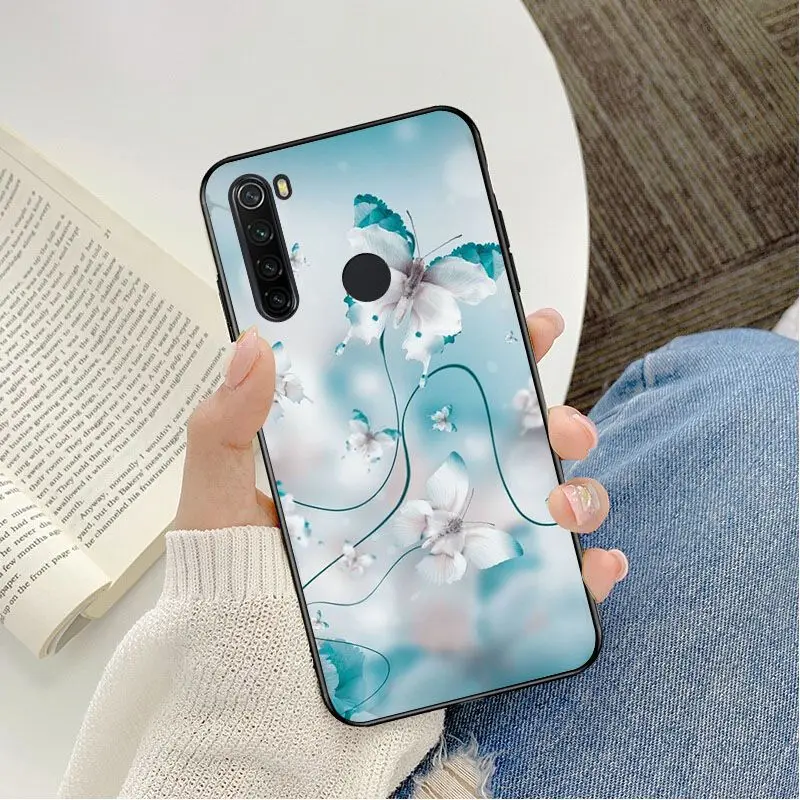 Red butterfly on white roses flower