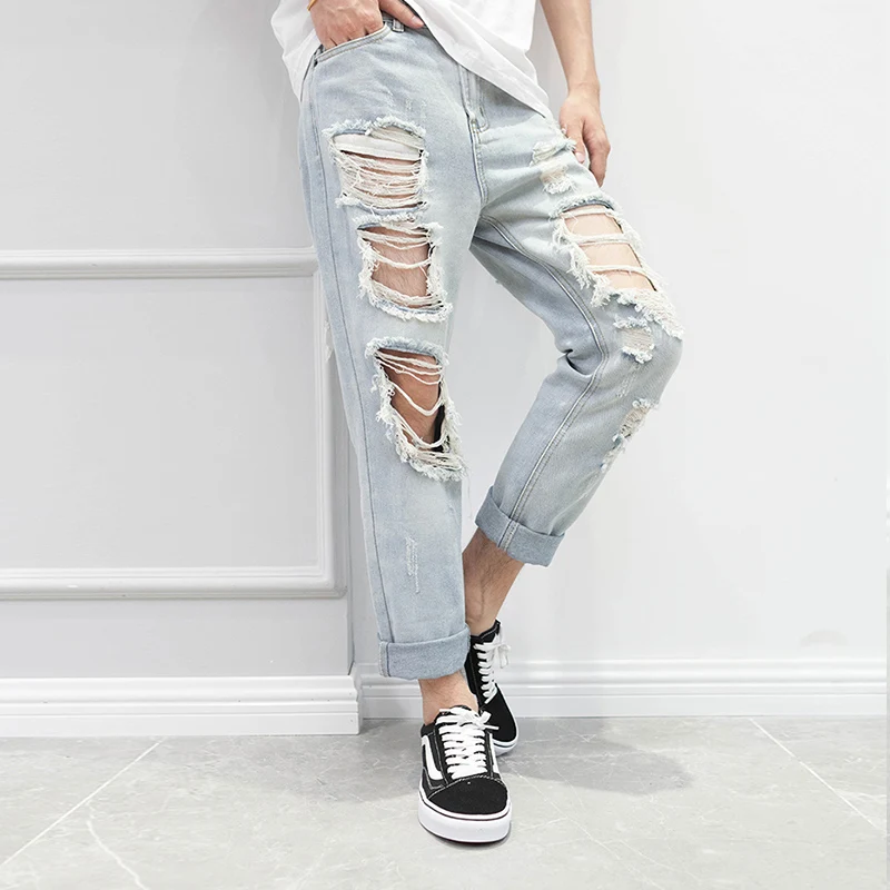 

Men's slacks Korean version of nine split pants hip hop ripped pants Men's knees ripped jeans nightclub stage wear