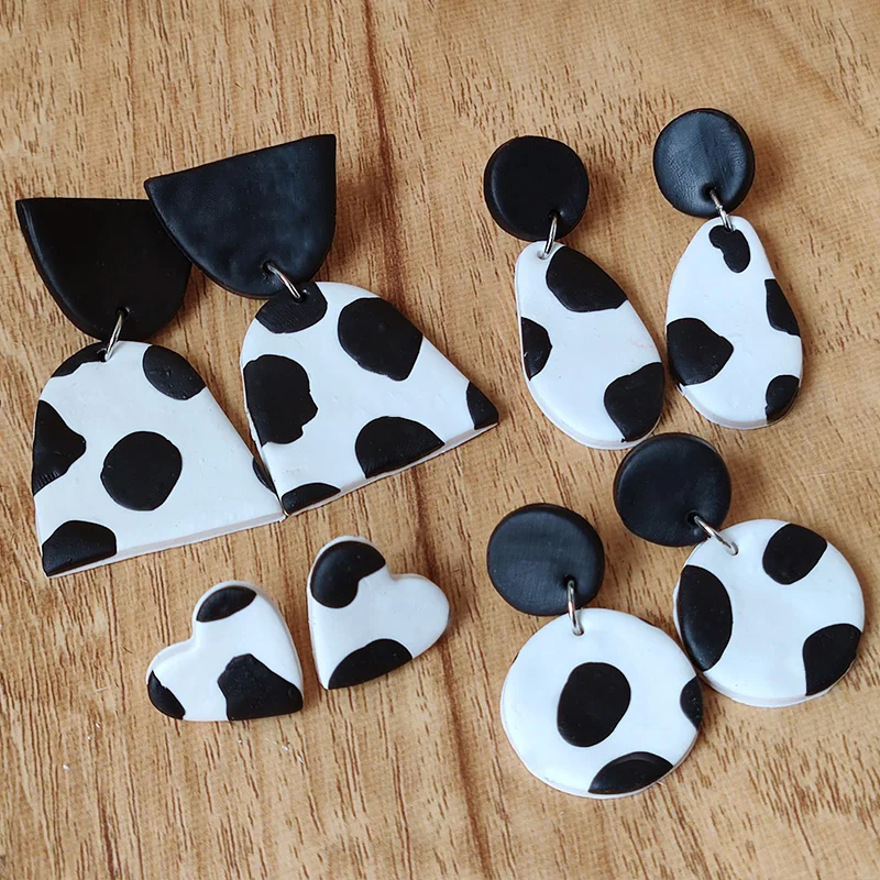 Cow print polymer clay dangle earrings made with leather effect clay.