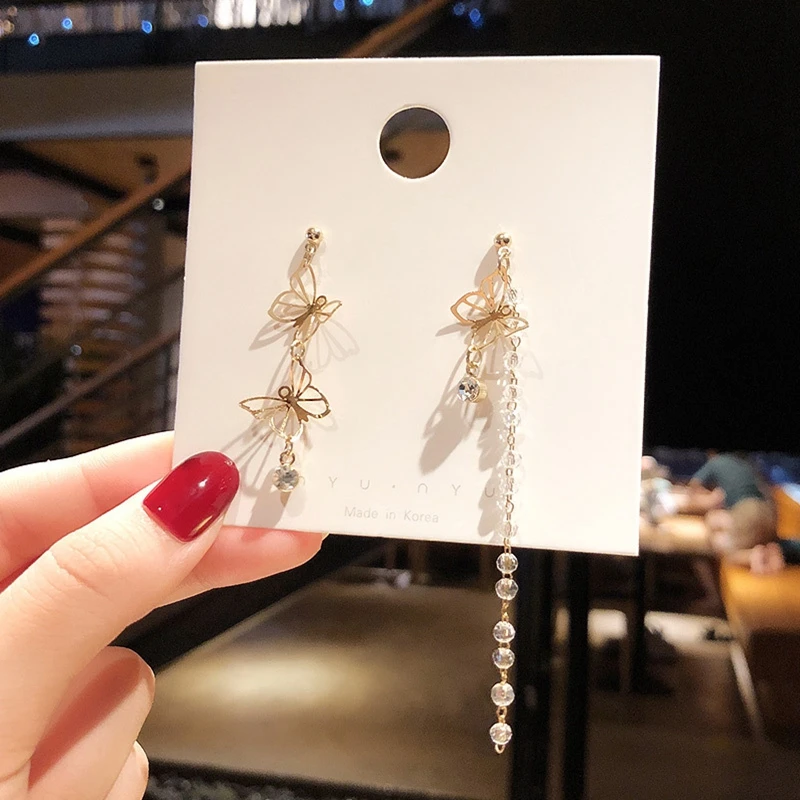 

Fashionable temperament bowknot earring female long only beautiful romantic asymmetric tassel advanced sense Korean earring