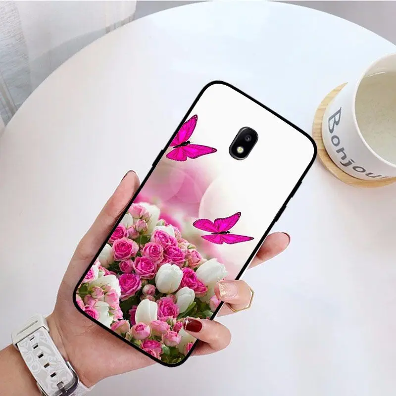 Red butterfly on white roses flower