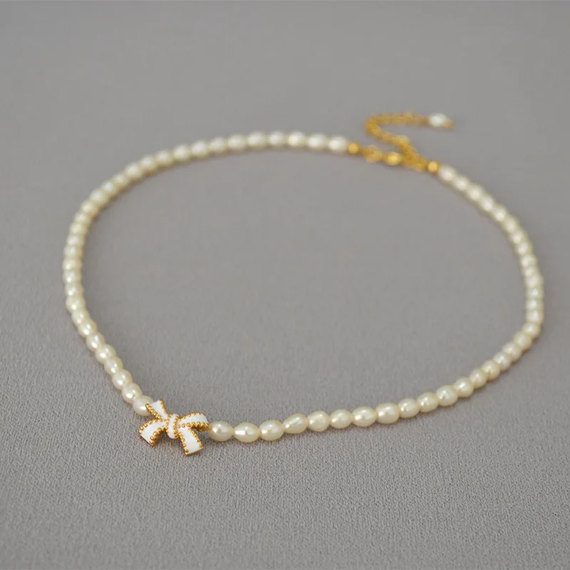 

Korea White Handmade Enamel Bowknot Freshwater Rice Pearl Short Necklace Clavicle Chain Female