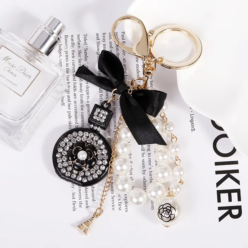 

Rhinestone Perfume Bottle Black Ribbon Bow Keychain Big Pearl Tassel Tower Charm key Ring Brand Camellia Key Chain llavero Z121
