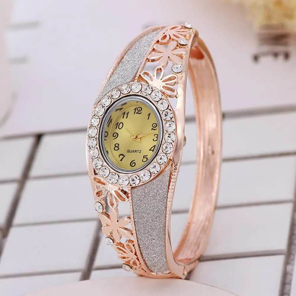 

Luxury Women Rhinestone Hollow Flower Band Oval Dial Analog Quartz Bangle Watch Reloj de mujer Fold-over Clasp Hollow Flower Ban