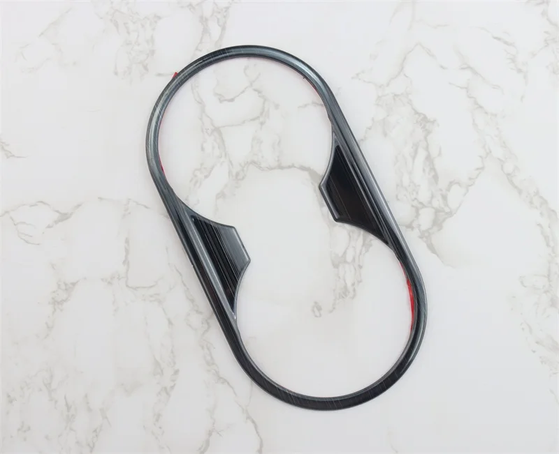 Black glossy plastic cup holder trim for Audi A4 B9 A5 gear panel with a sleek oval-shaped design.