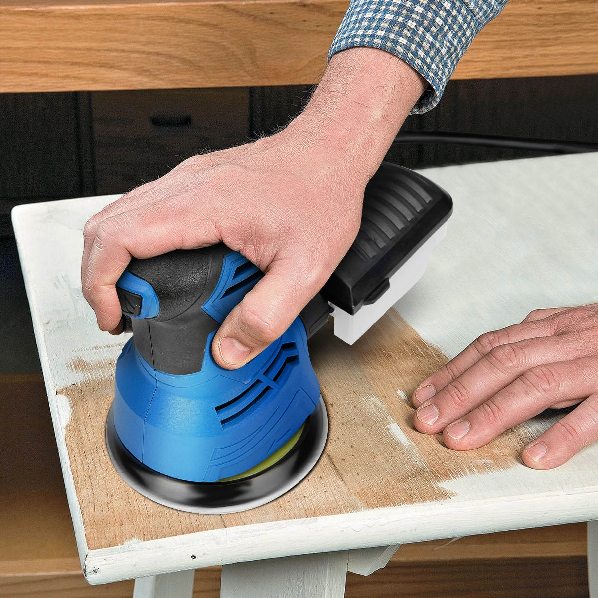 orbital sander while in use over the wood