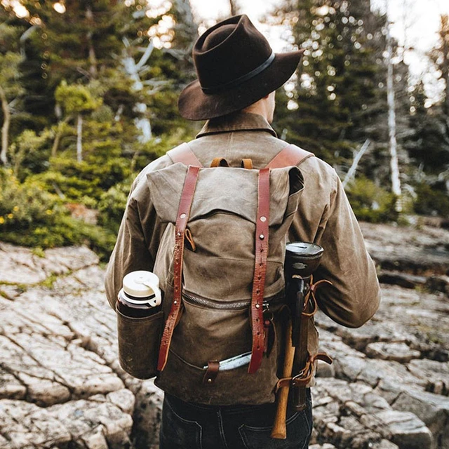 Waxed canvas backpack with roll up top and hand waxed leather bottom and  outside pocket