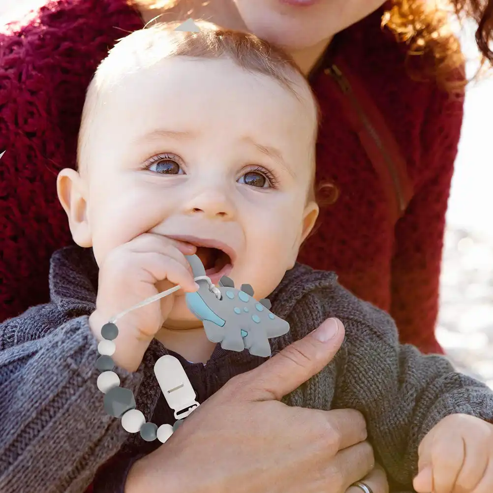baby chewing on pacifier teething