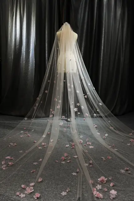 The perfect addition to your wedding ensemble. Priced at $78.00 with free shipping, this luxurious, handmade wedding accessory is made from high-quality materials such as acetate and nylon. Elevate your bridal look with this elegant cathedral veil featuring a cut edge. Look stunning and feel like a princess on your special day.