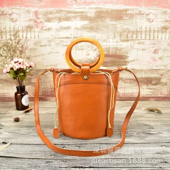 

2019new women's bag First layer of leather design luxury package keg Cylinder package Round wooden handle Shoulder Messenger Bag