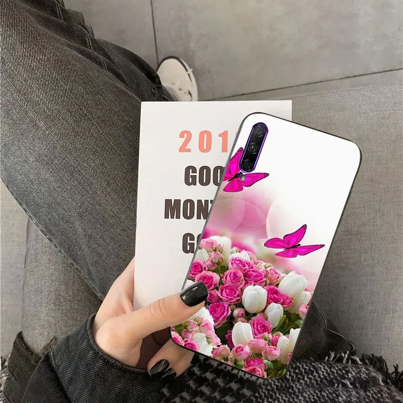 Red butterfly on white roses flower