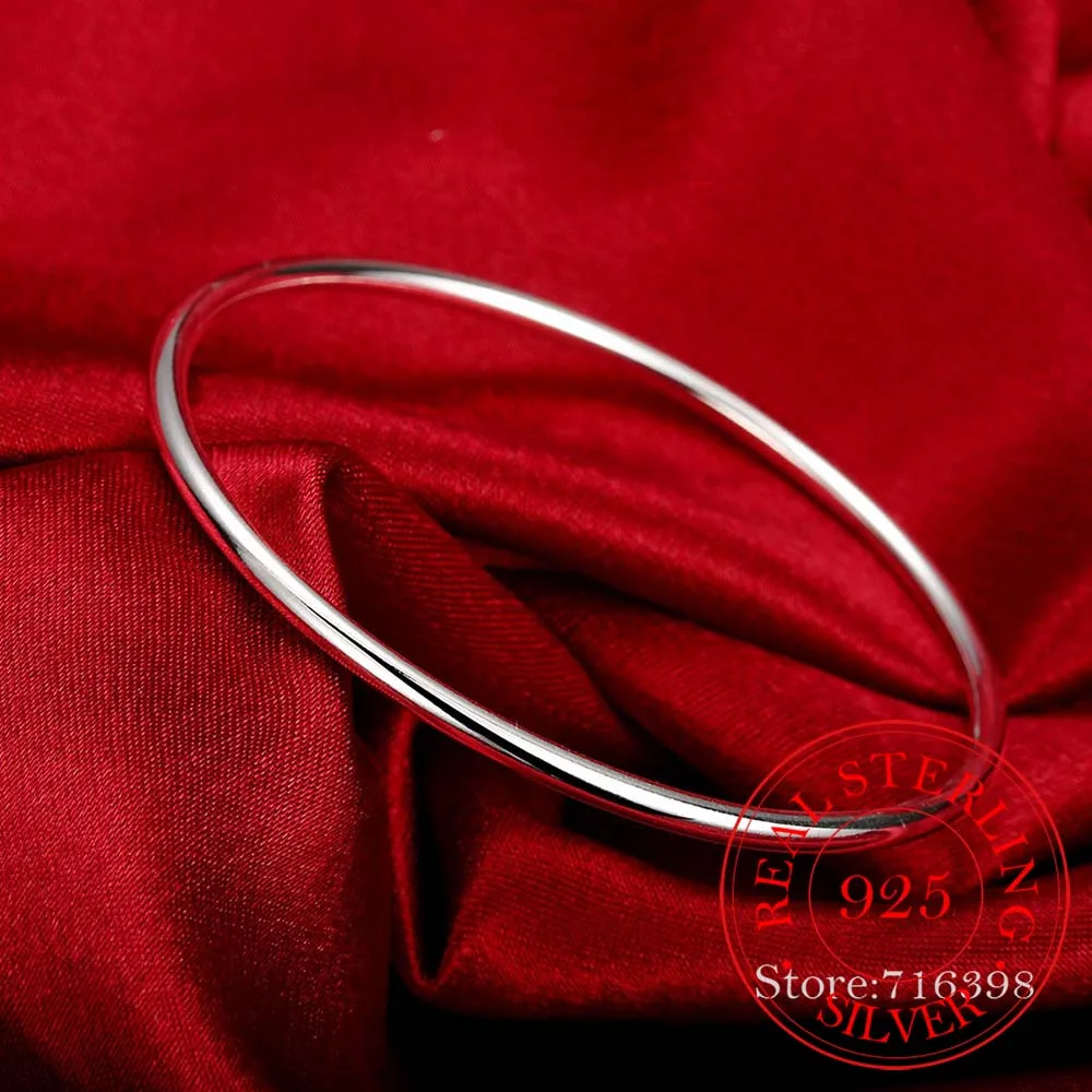 Smooth silver bangle on wrist