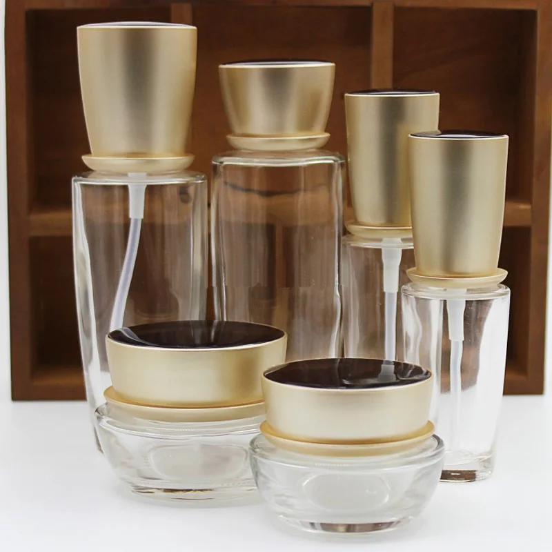 

Empty Cosmetic Glass Container With Matte Gold Tops Skin Care Cream Jar Lotion Cream Pump Essential Oil Liquid Glass Bottle