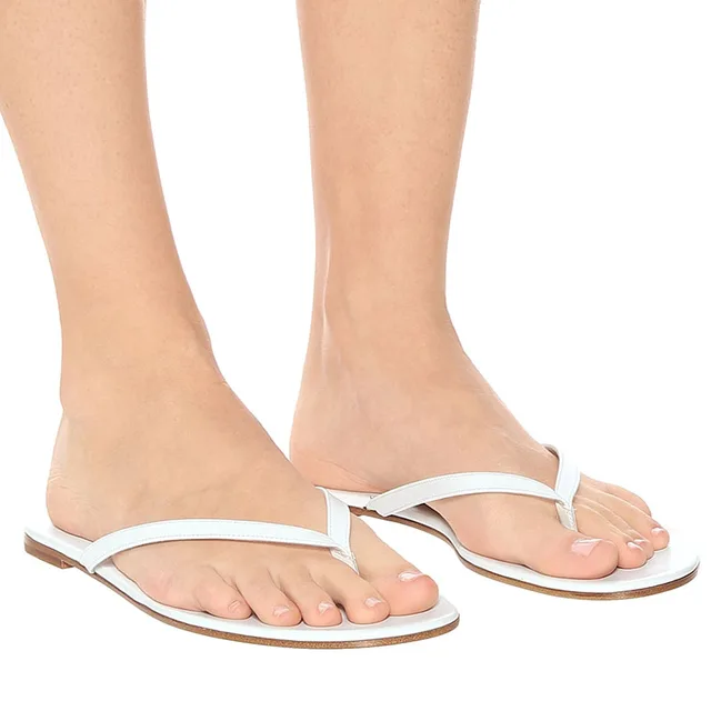 white and gold flip flops