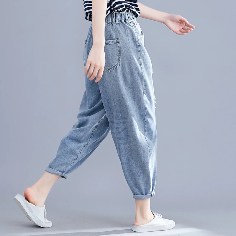 Real shot spring new women's wash water denim pocket solid color hole elastic nine points harem pants wild