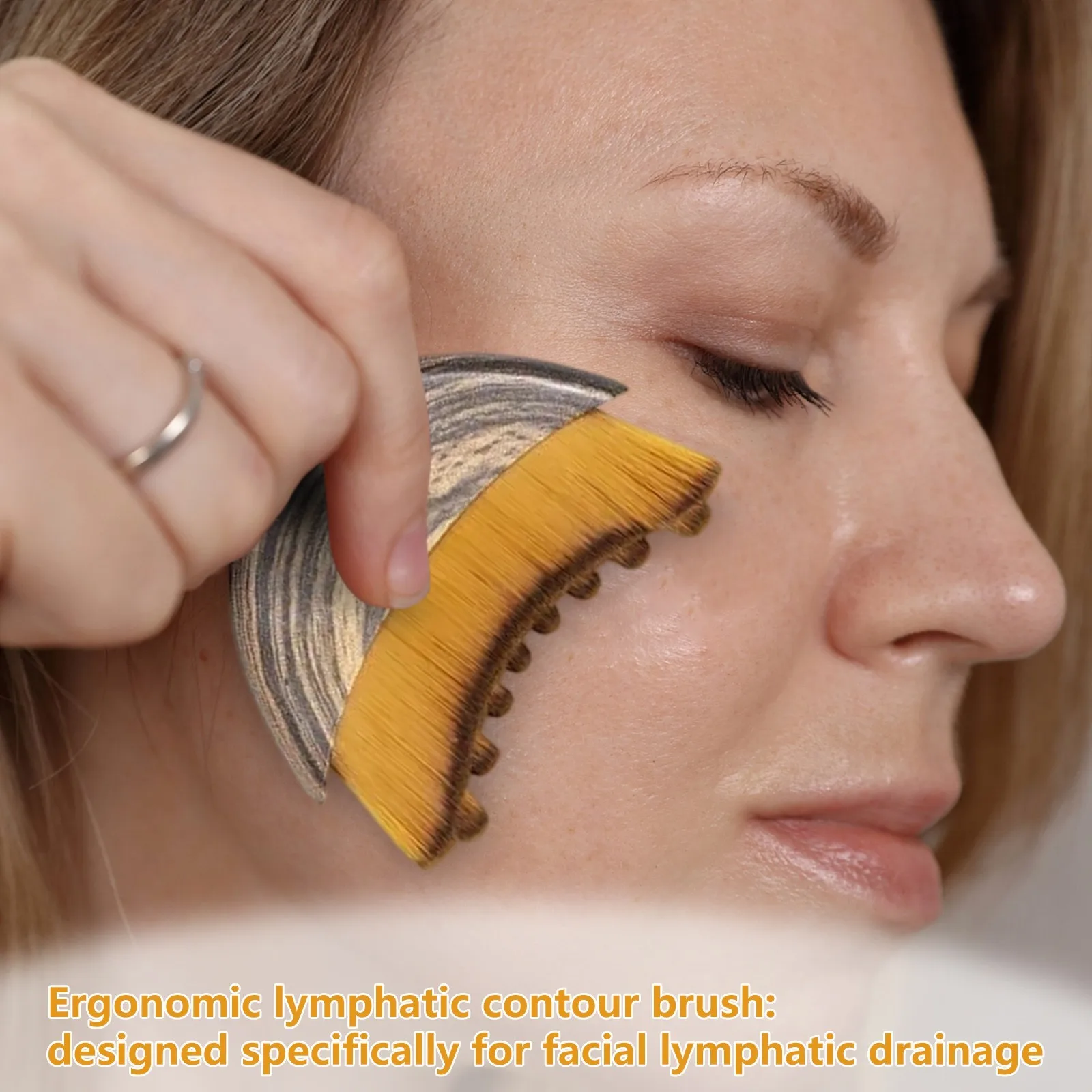 Ergonomic lymphatic drainage face brush with ultra-soft bristles, designed to reduce puffiness and improve facial circulation.