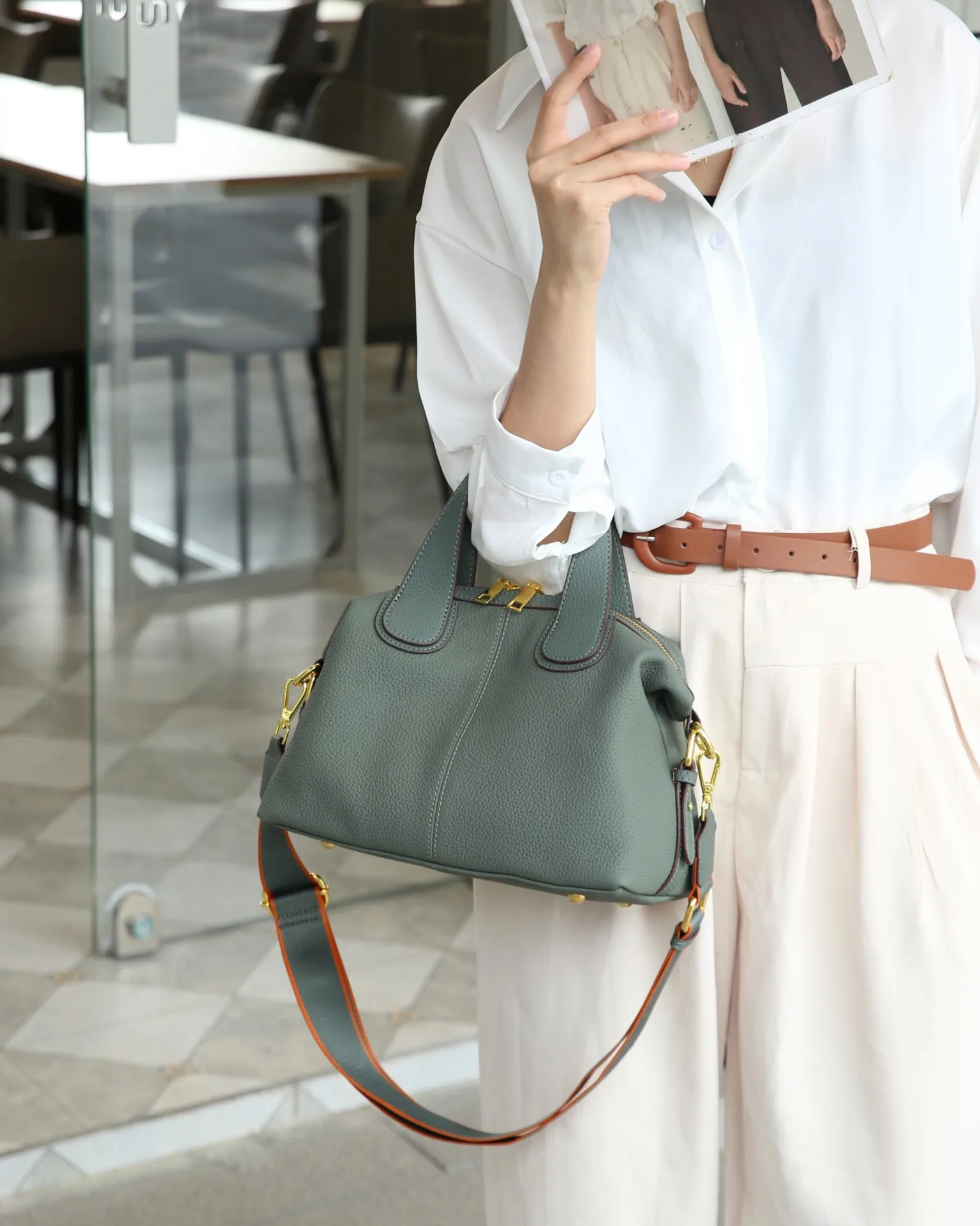 Elegant genuine leather crossbody handbag with shoulder strap and quality details