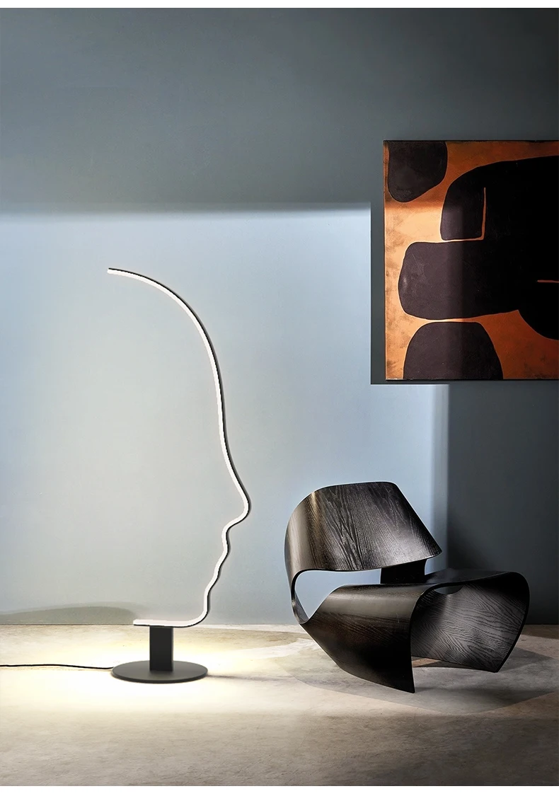 A chair and a floor lamp creating Nordic flair in a room with a painting.