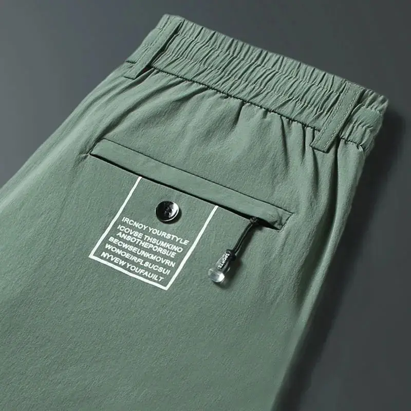 2024 New Summer Men's Ice Shreds Thin Style Trousers Solid Color Elastic Button Zipper Fashionable Loose Casual Harlan Pants