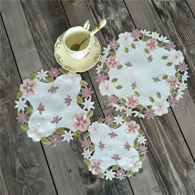 Stylish and versatile modern table place mat pad with embroidered design.