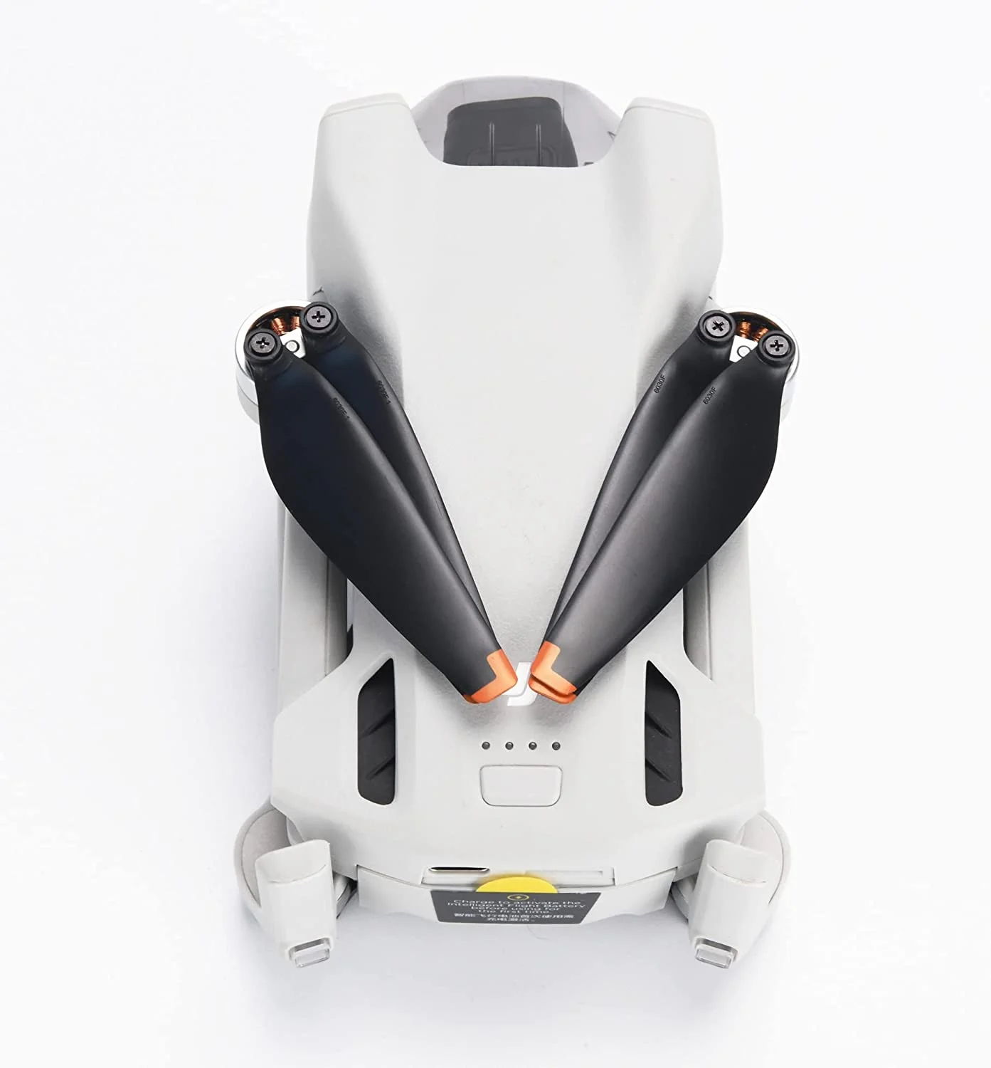 Housse de protection pour DJI Mini 3 Pro et Mini 3 posée à côté du drone, illustrant sa flexibilité et sa couleur noire.