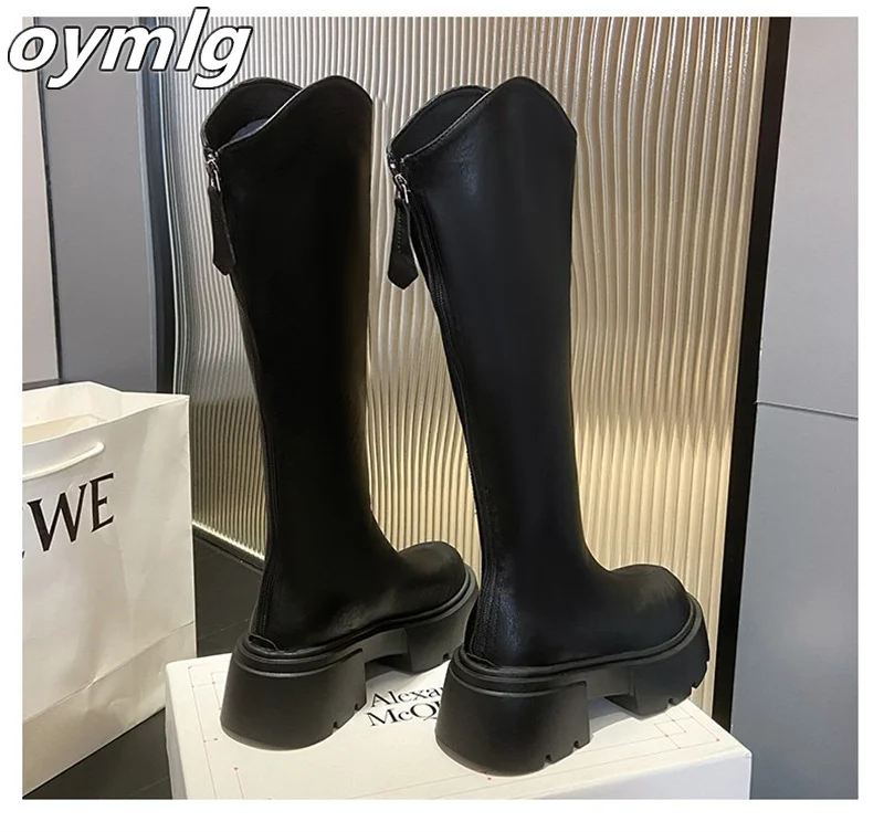 Thick heeled boots that are no less than knee high and appear slim with V-shaped boots