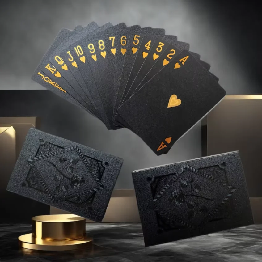 Black and gold playing cards stacked in a fan shape