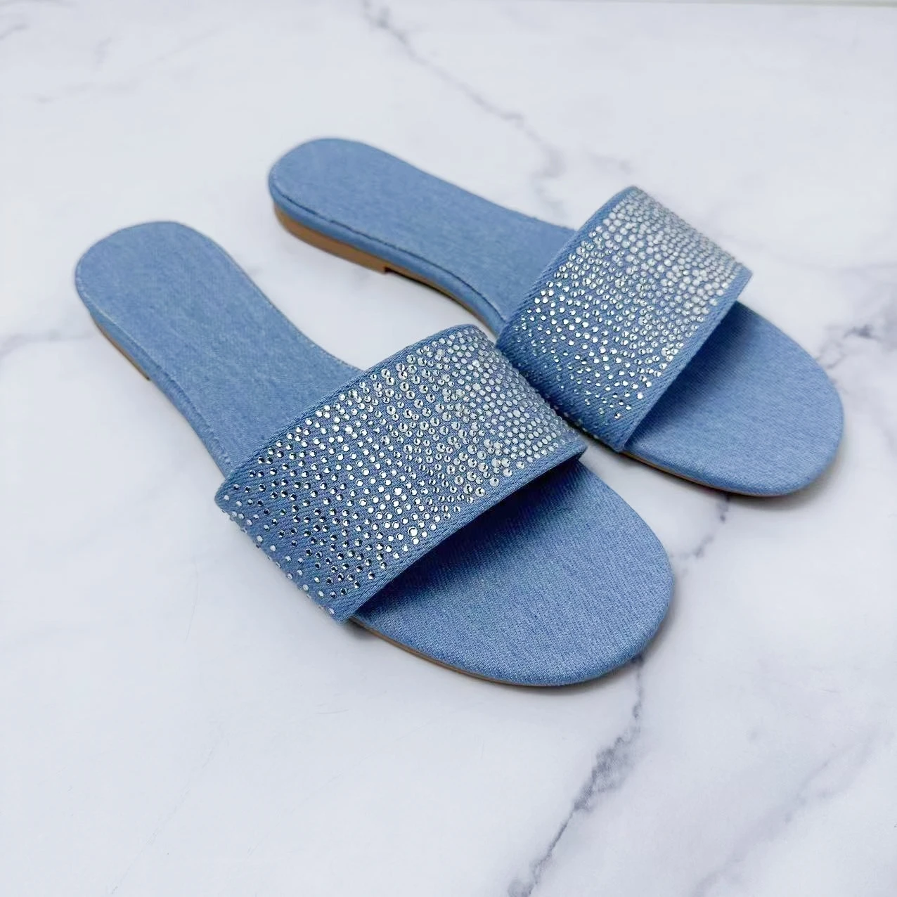 

The New 2024 Women's Shoes Are Stylish and Flat With Blue Rhinestones. Open-toed Sandals Are Worn By Women.