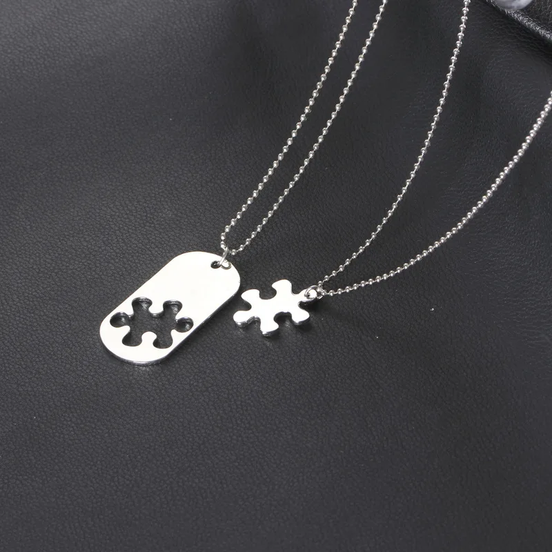 Romantic matching heart puzzle necklaces styled flat lay