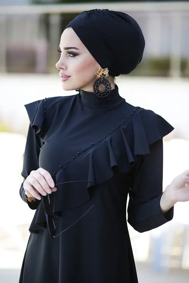 Lifestyle image of woman at the pool in navy modest bathing suit set