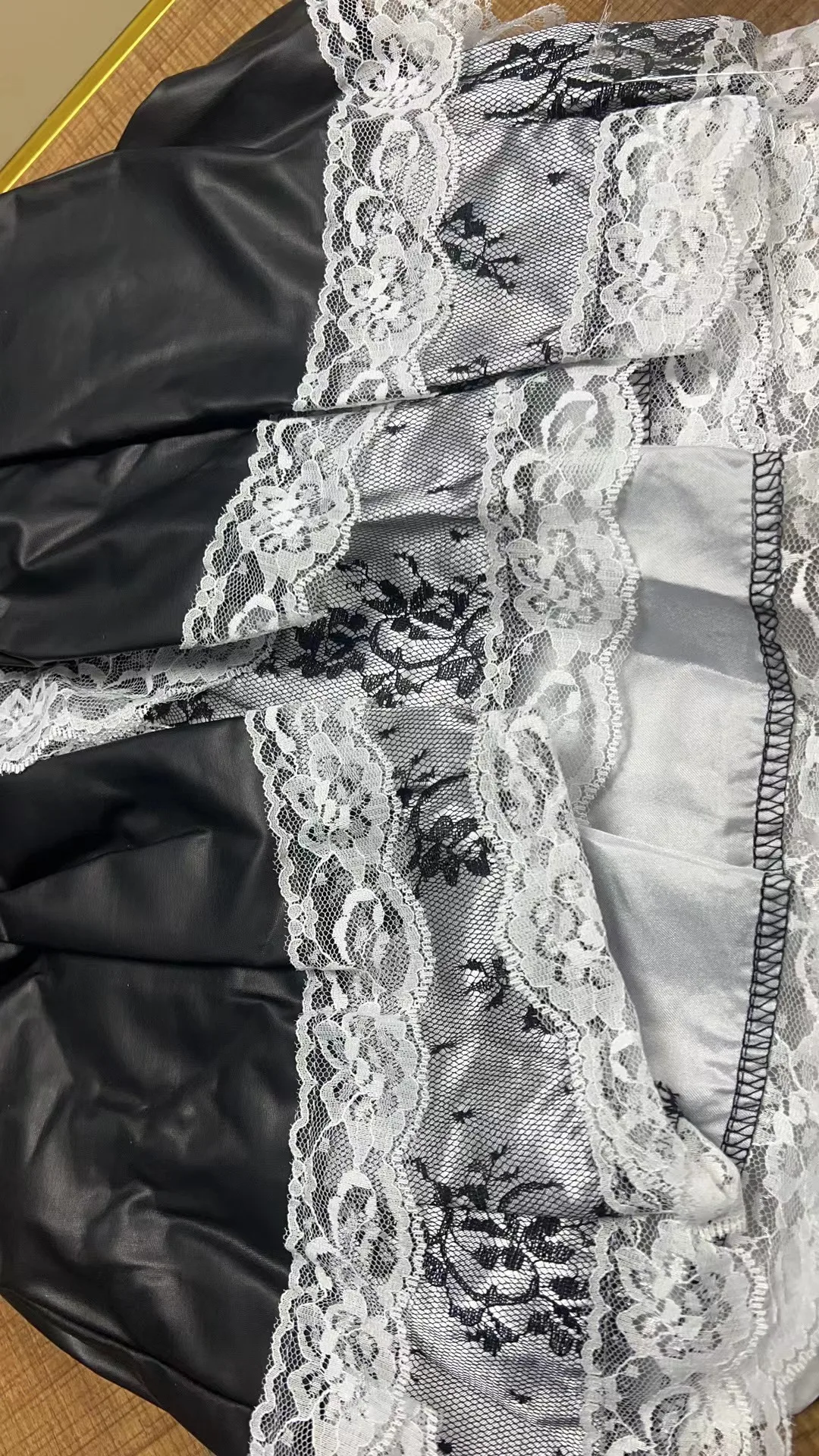 Classic black costume dress with white lace accents for cosplay styling