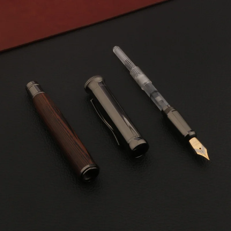 Wood fountain pen placed on notebook for writing