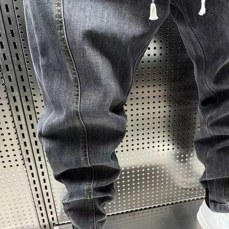 New Arrival Korean Style Fashion Stretch Denim Jeans for Men Elastic Waistband Drawstring Design Harem Jeans Cotton Trousers