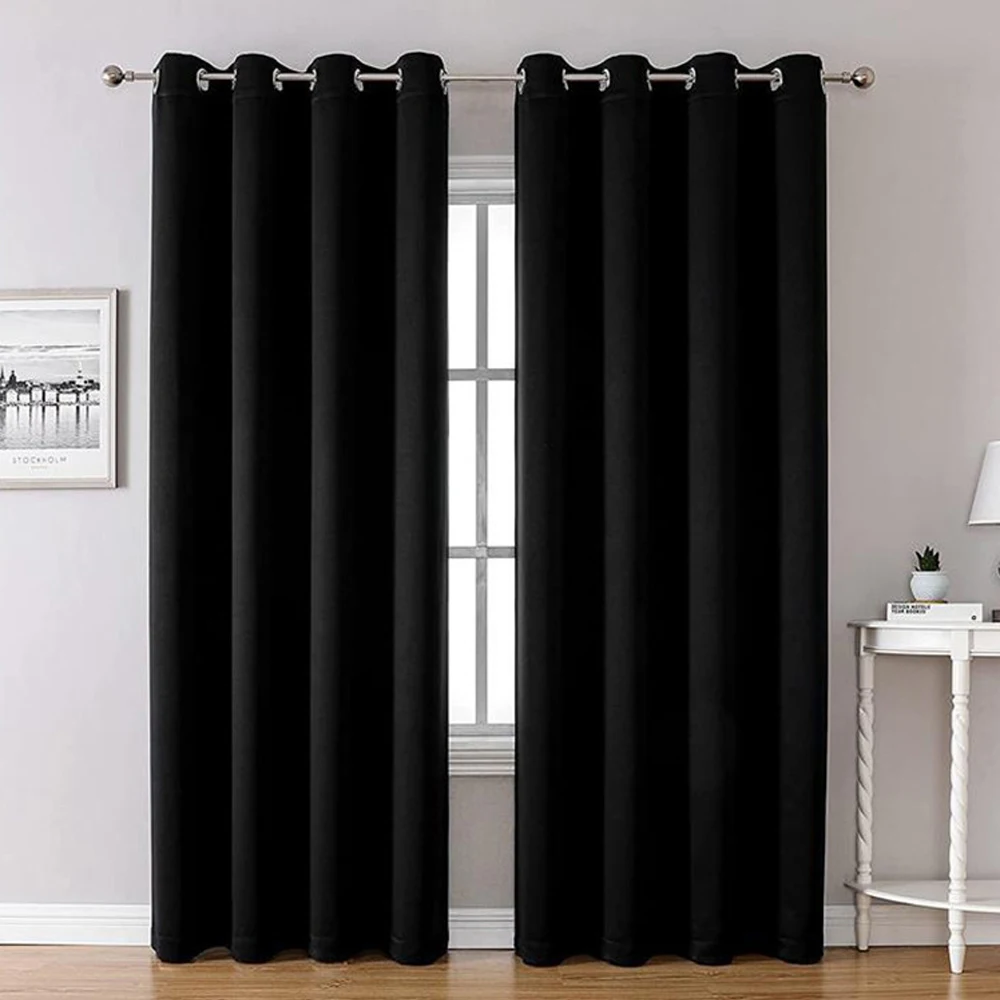 Black 120 GSM blackout curtain panel at a window
