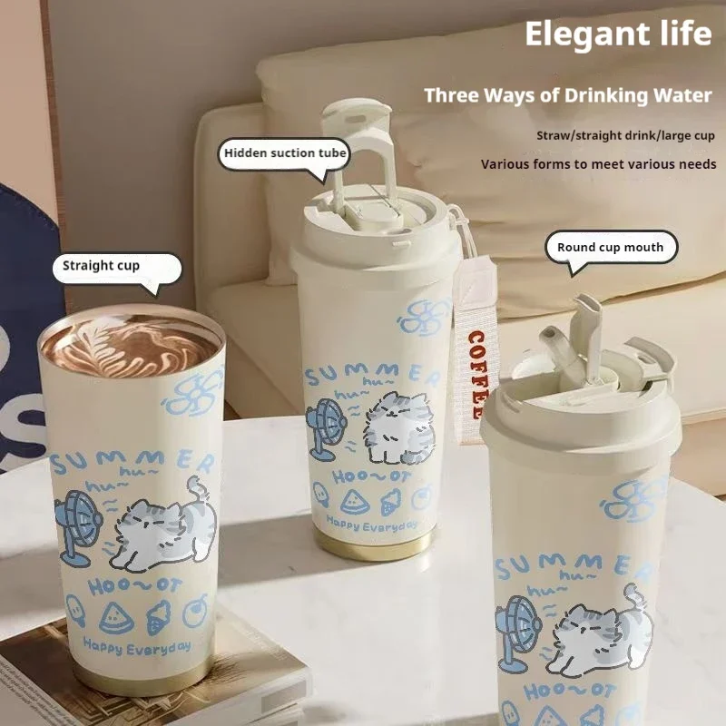 KittyNook Cat Co.'s Cartoon Kitty Stainless Steel Travel Cups in three styles shine on a beige surface in sunlight.