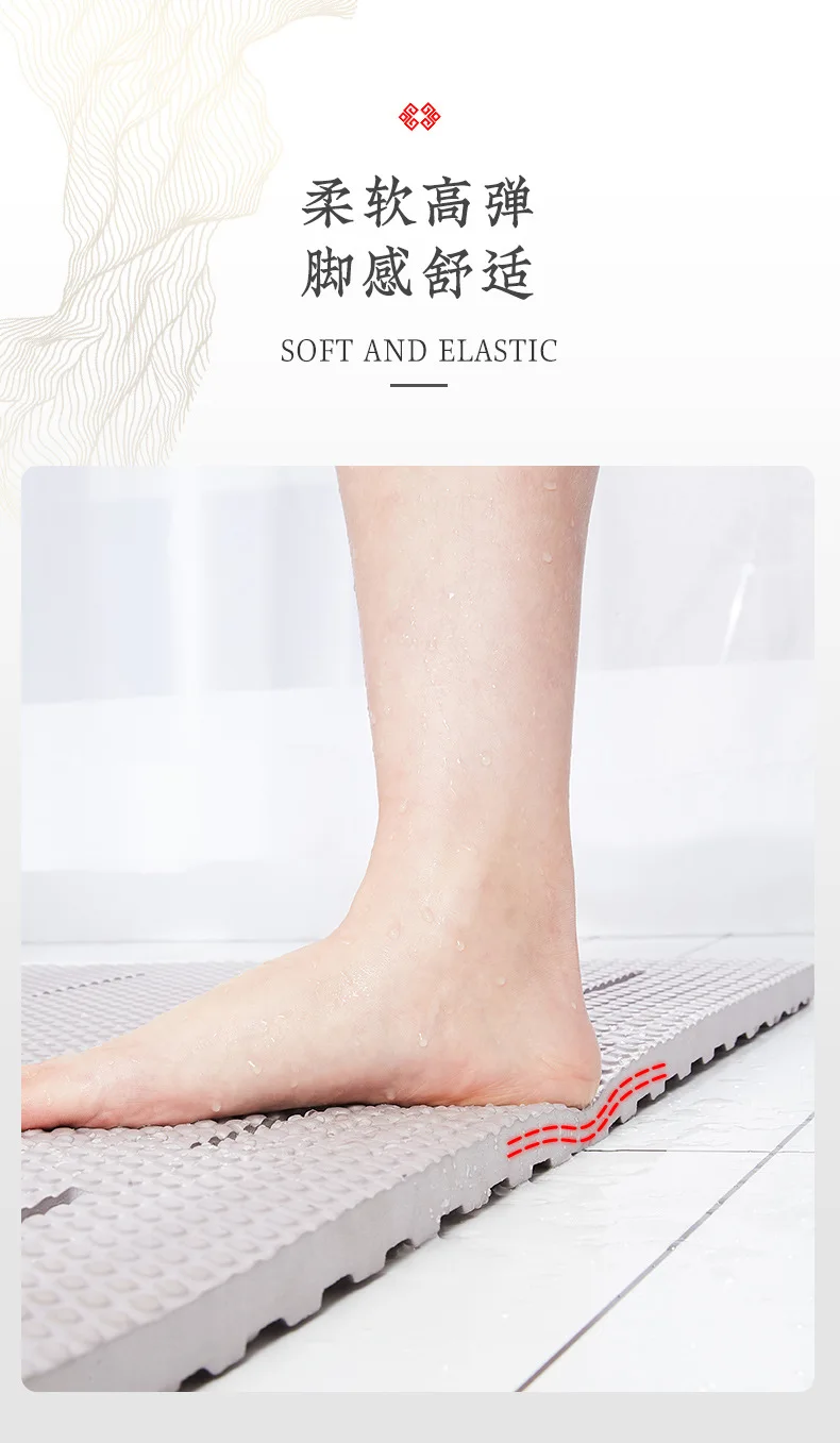 White non-slip bathroom mat with suction cups on a wet shower floor.