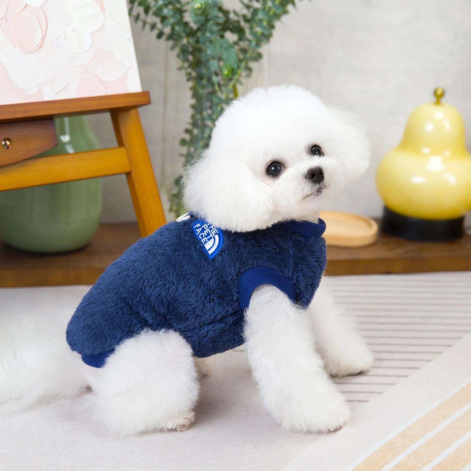 2024 New Dog Clothes Winter Dog Sweater for Small Dogs Warm Thermal Fleece Puppy Pullover Yorkie Chihuahua Pet Apparel 17 A small Chihuahua wearing a Warm Winter Dog Sweater made of soft thermal fleece, sitting on a cozy white rug with snowflakes gently falling in the background. The sweater features a stylish design with a snug fit, perfect for keeping the dog warm and comfortable during chilly winter days.