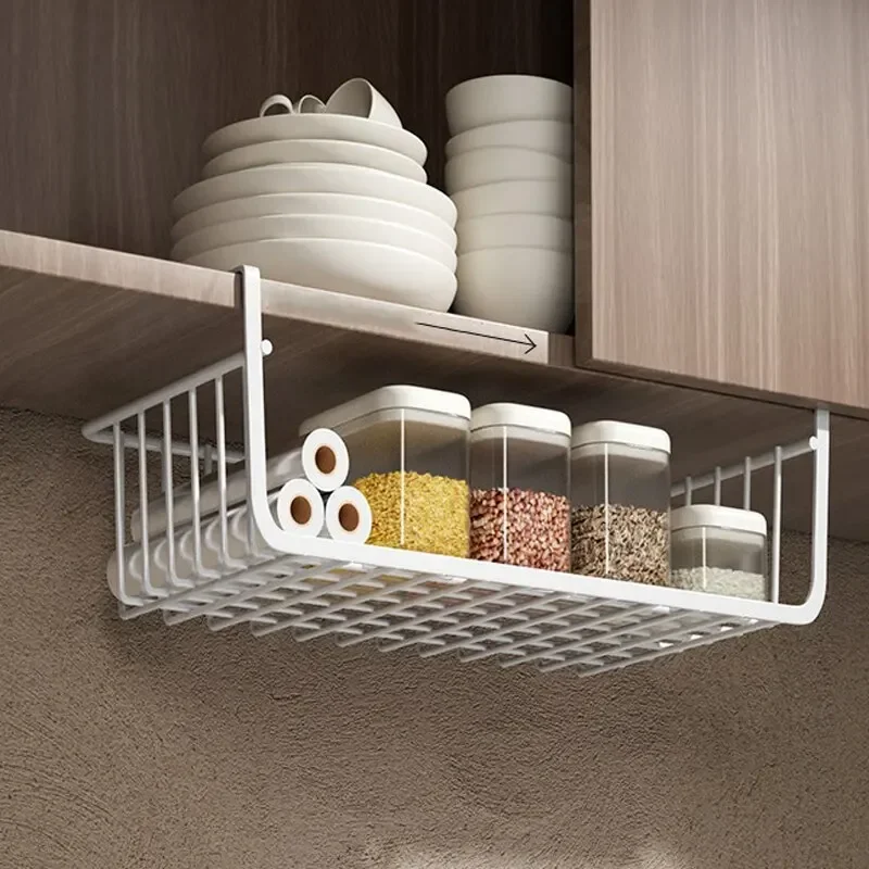 A white under shelf basket hanging from a pantry shelf, neatly holding boxes of aluminum foil and plastic wrap.