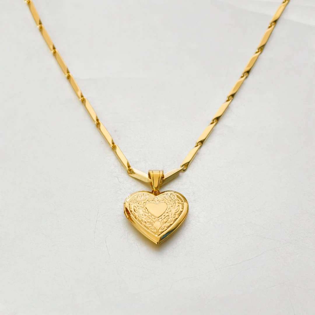 Heart necklace styled flat lay with romantic accents