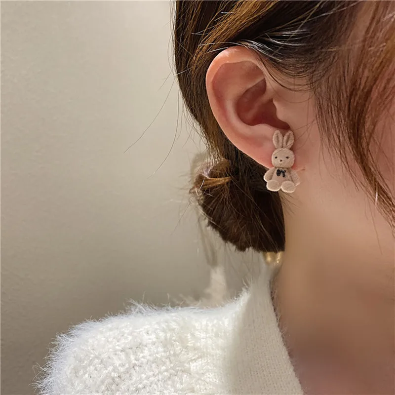 A woman wearing a pair of Rabbit Bear Earrings for Women.