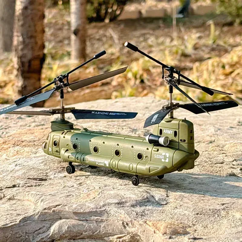 Enfant pilotant l'hélicoptère RC Chinook Transport Militaire dans un parc