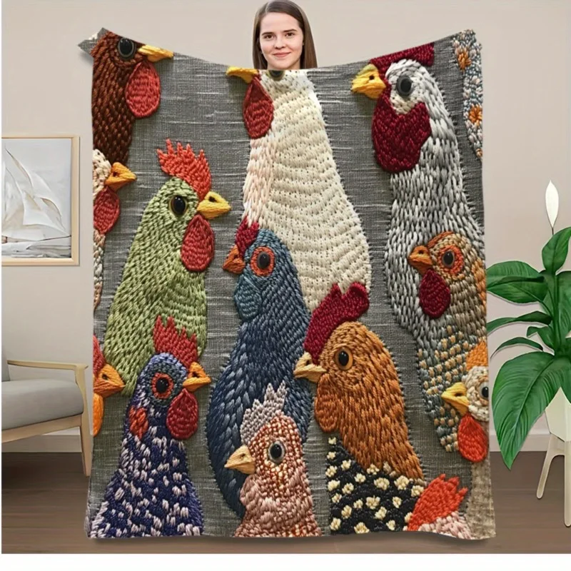 A woman holding a gray fleece blanket featuring a colorful vintage rooster and chicken pattern.
