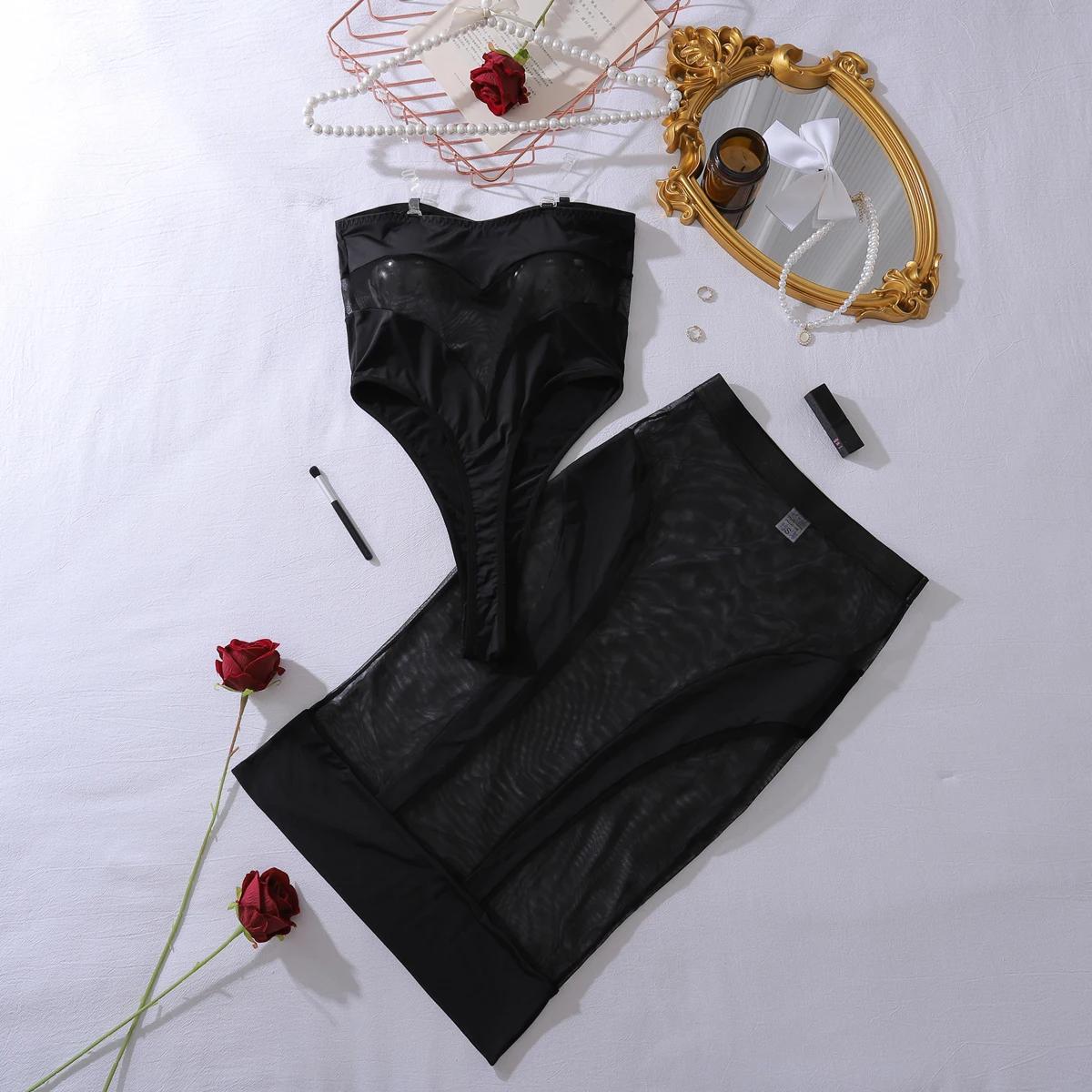 Bodycon lingerie look with solid black fabric, sheer panels, and polished private appeal