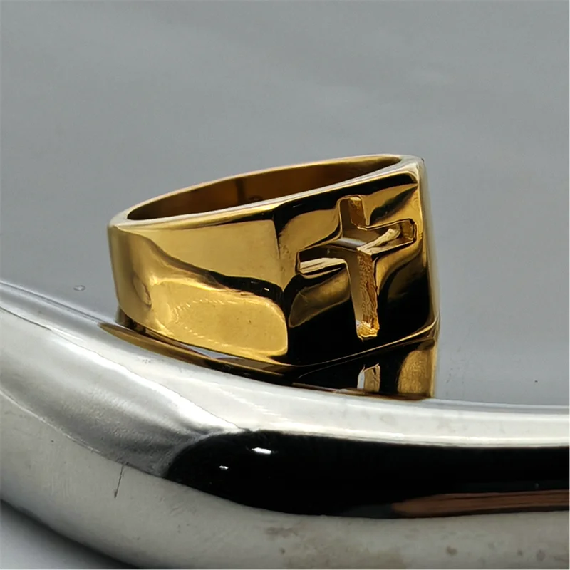 Gold 316L stainless steel hollow out cross ring for men and women displayed on a reflective surface.
