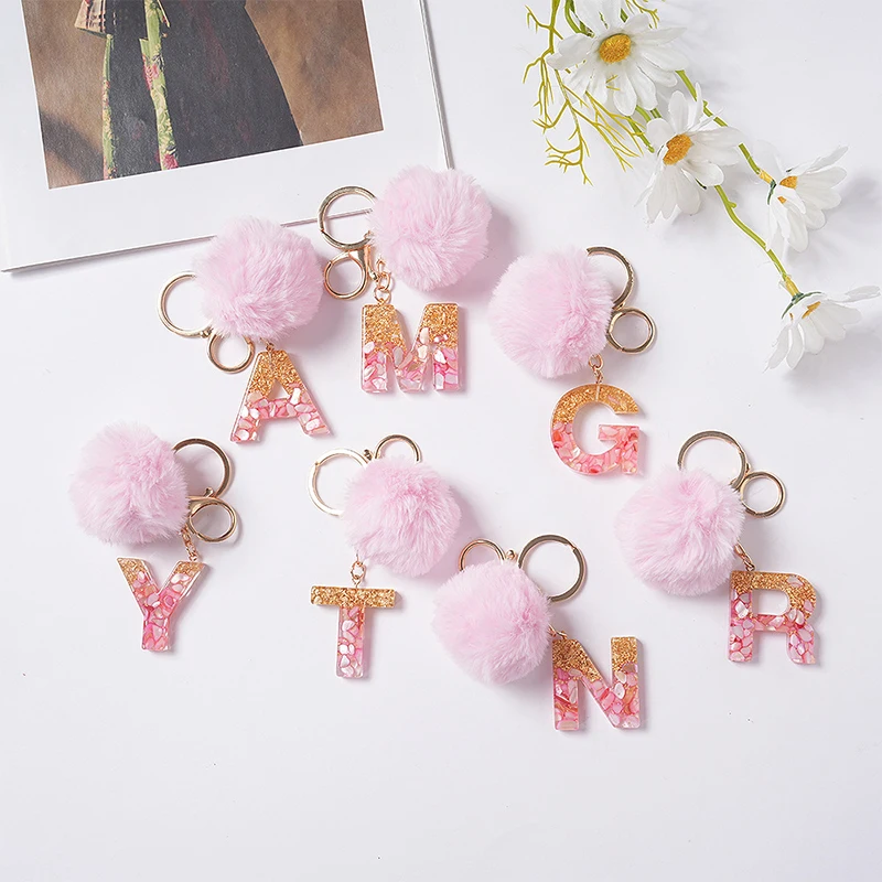 pink initial keychain with pom pom