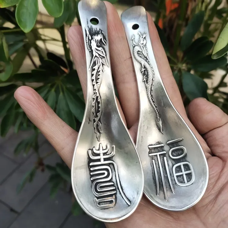 

A pair of handcrafted silver plated dragon and phoenix longevity spoons with exquisite craftsmanship in home decoration